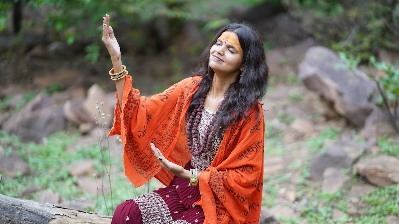 gallery-5 Woman meditating outdoors in a serene natural setting, embracing peace and spirituality.